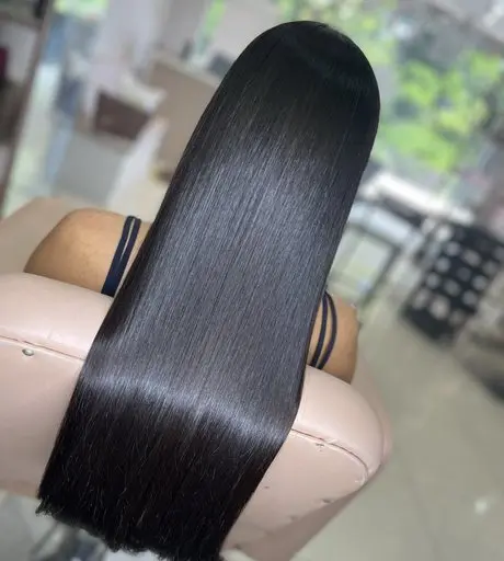 Straight dark hair with the length fitted, seen over the studio chair
