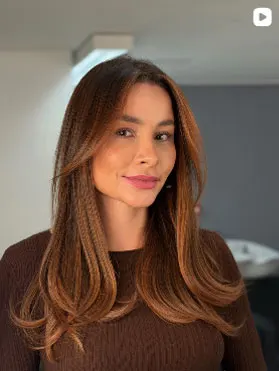 Client with highlighted brown hair extensions, straight with defined ends